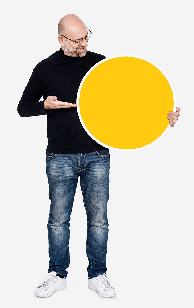 Happy man holding round yellow board
