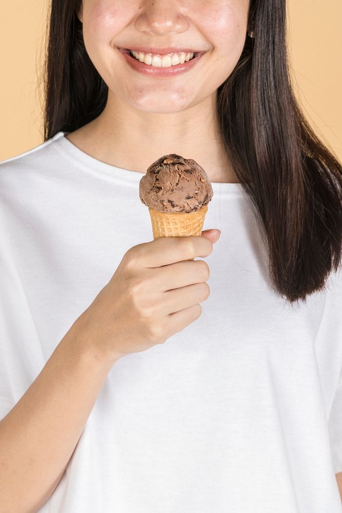 Happy woman with a chocolate ice cream in her hand