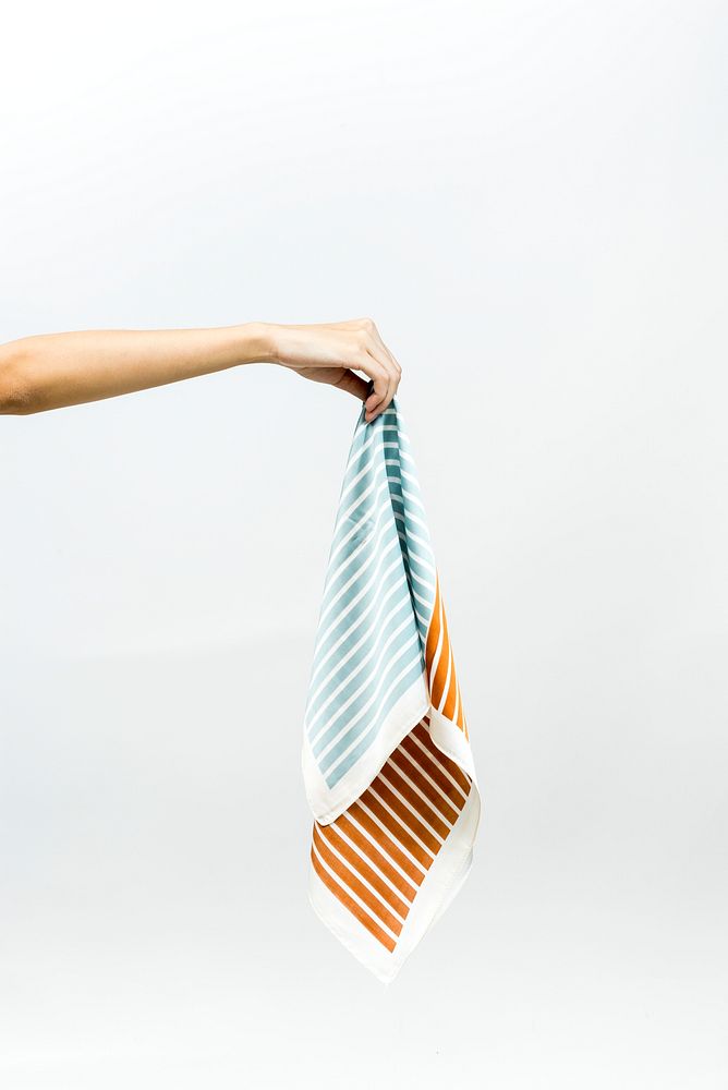 Hand picking up a striped scarf