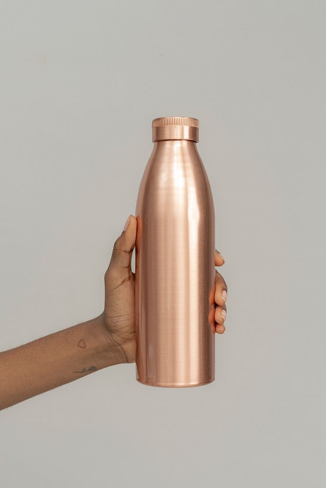 Hand holding a copper stainless steel bottle