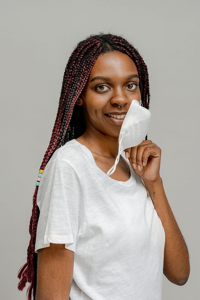 Smiling black girl with a face mask