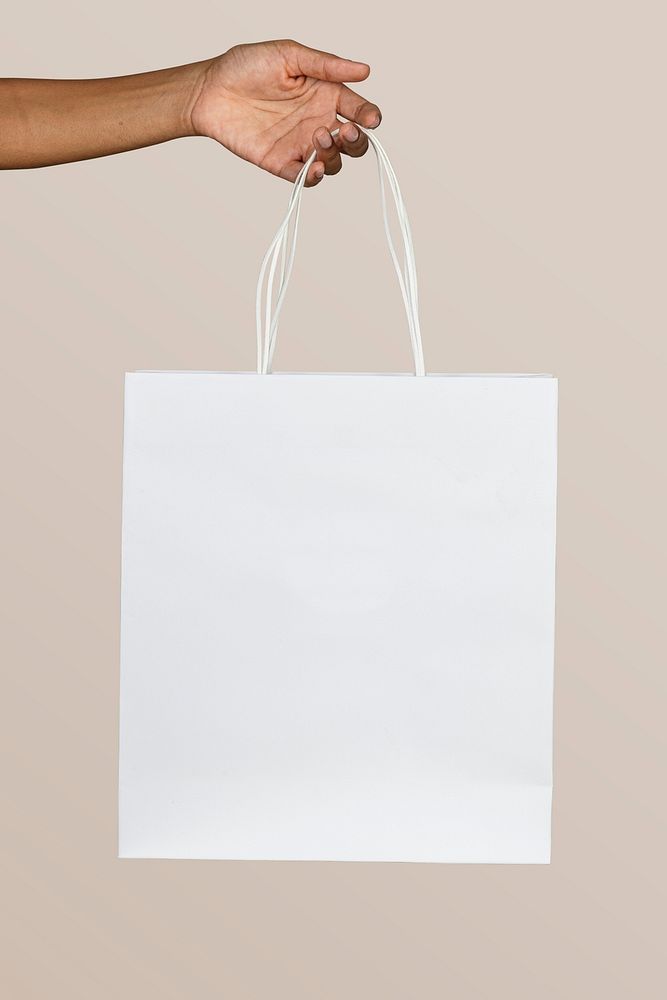 Black woman holding a white paper bag mockup