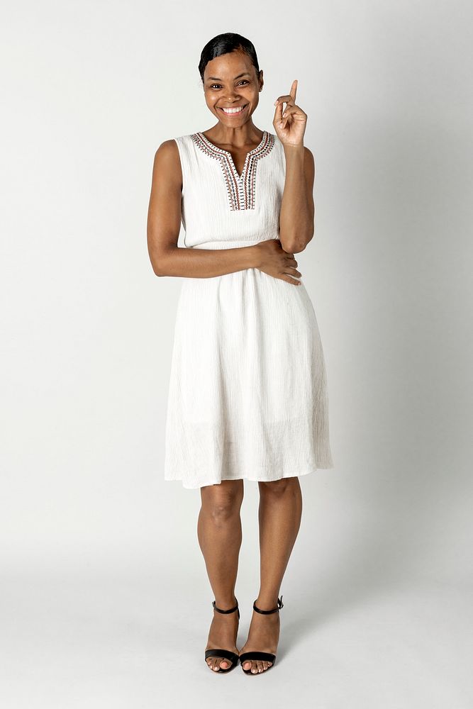 Happy black woman in a white dress