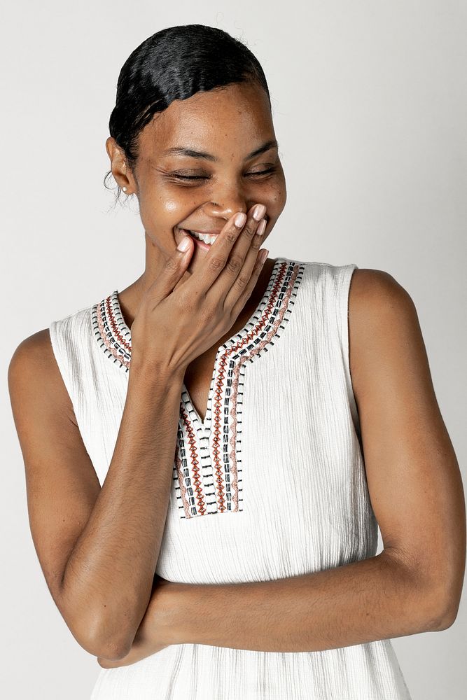 Laughing black woman in a white dress