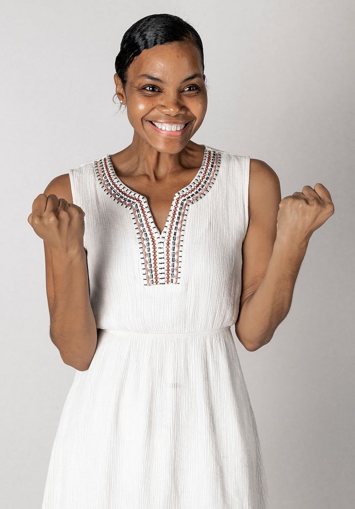 Happy black woman in a white dress