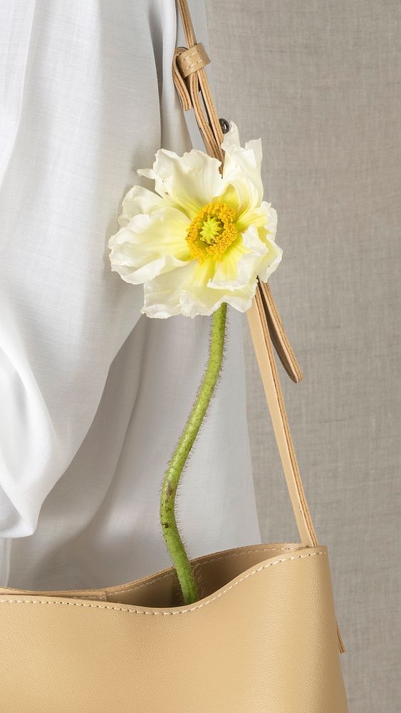 White poppy flower in a beige bag 
