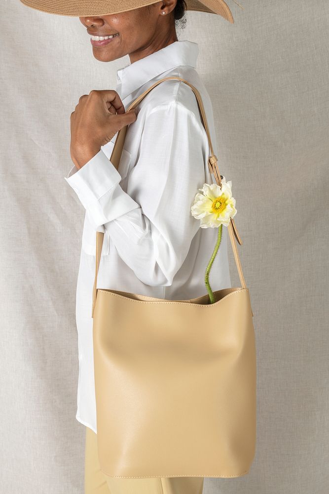 Black woman carrying a beige shoulder bag mockup