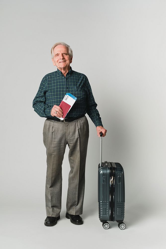Senior man traveler with air ticket and passport carrying luggage