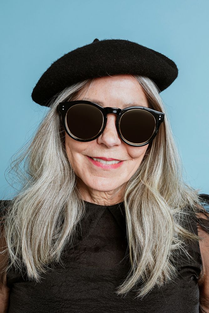 Beautiful senior woman in a cool beret and sunglasses