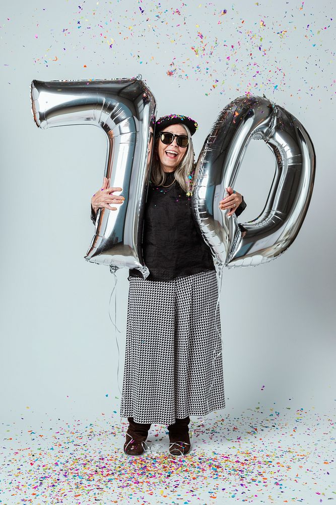 Cool grandma celebrating her 70th birthday with balloons