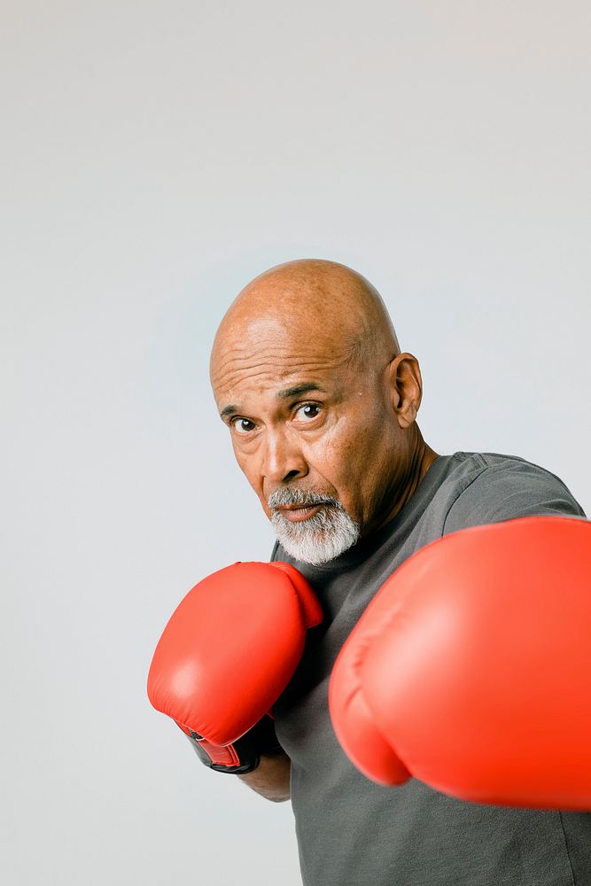 Senior man with red boxing gloves