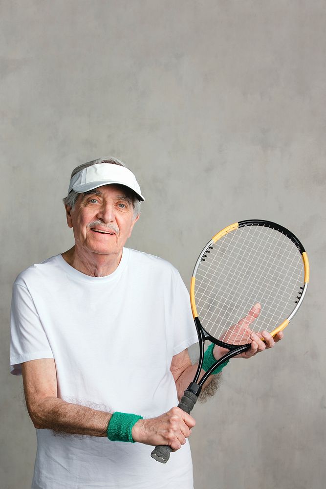 Cheerful senior man with a tennis racket