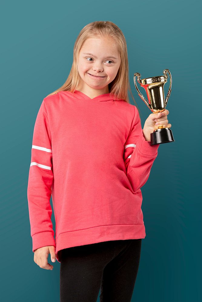 Young girl with down syndrome holding a trophy 