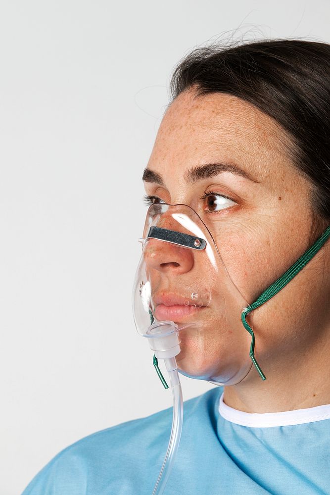 Sick female patient with an oxygen mask