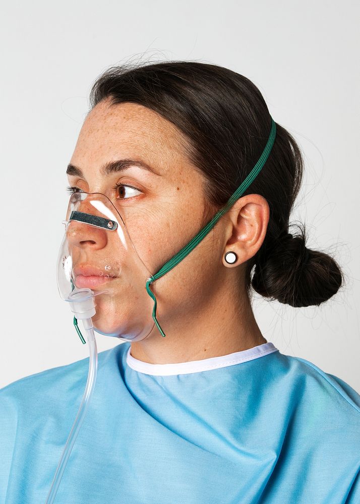 Sick female patient with an oxygen mask