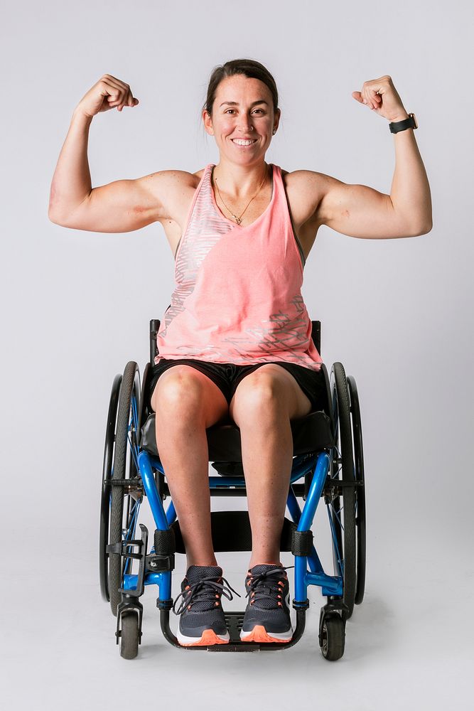 Athlete in a wheelchair flexing her arms 