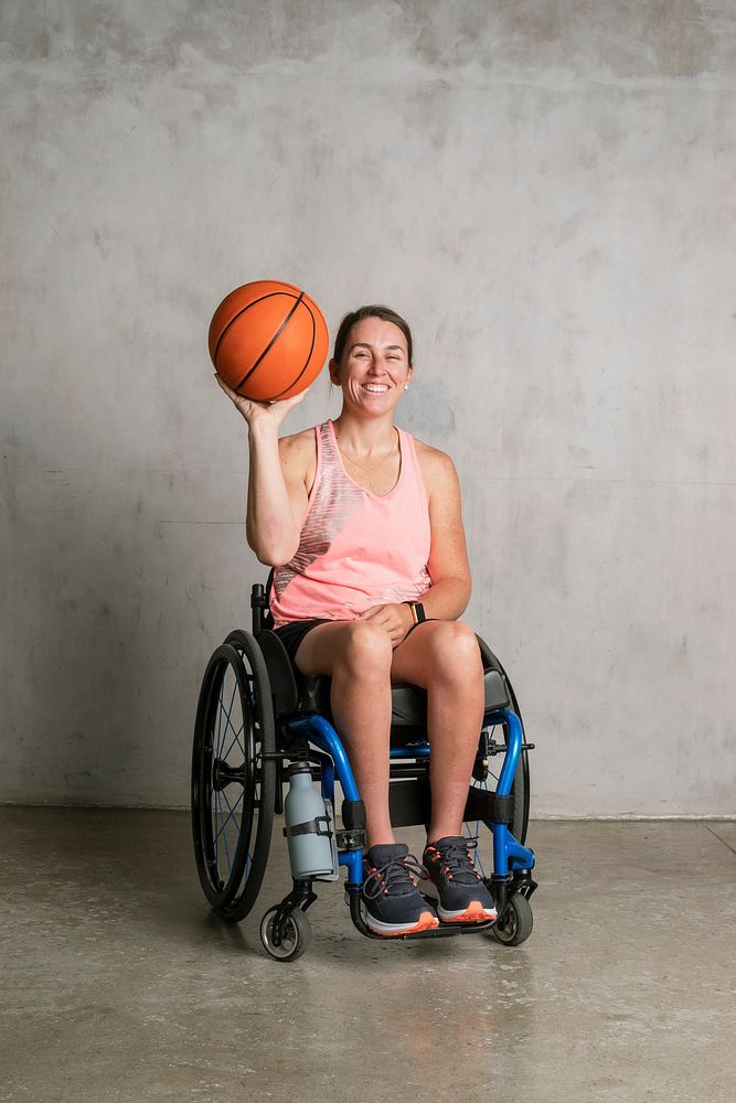Female athlete in a wheelchair holding a basketball