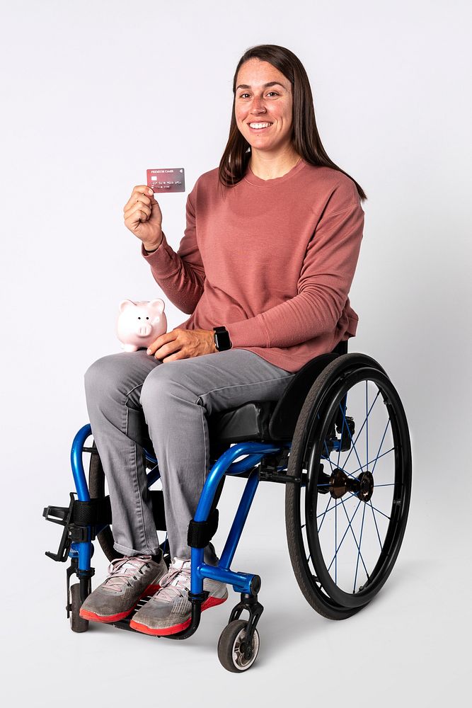 Cool woman on a wheelchair showing a premium credit card