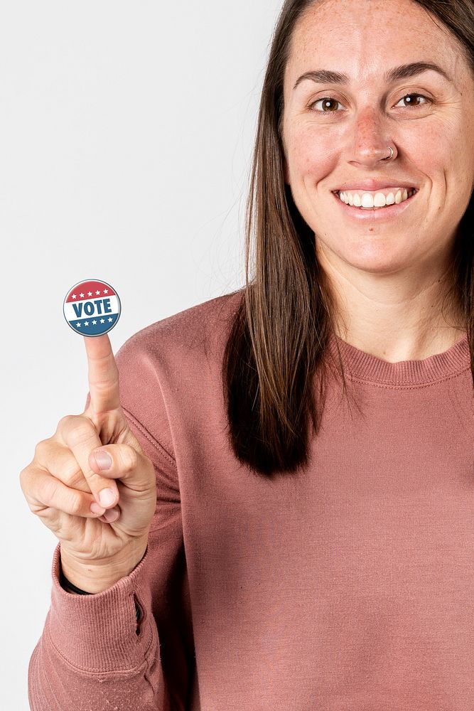 Cheerful woman with a vote sticker on her index finger