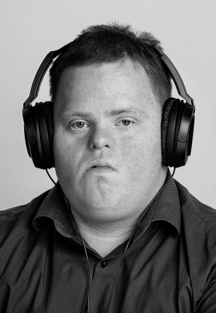 Young man with Down syndrome listening to some news