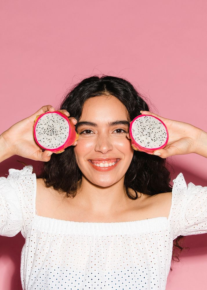 Woman holding sliced dragon fruits 