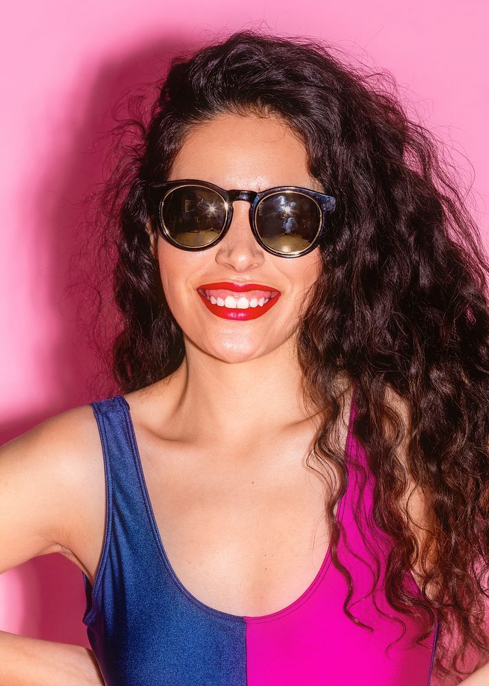 Happy woman in a bathing suit wearing sunglasses 