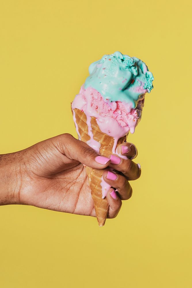 Hand holding a melting ice cream