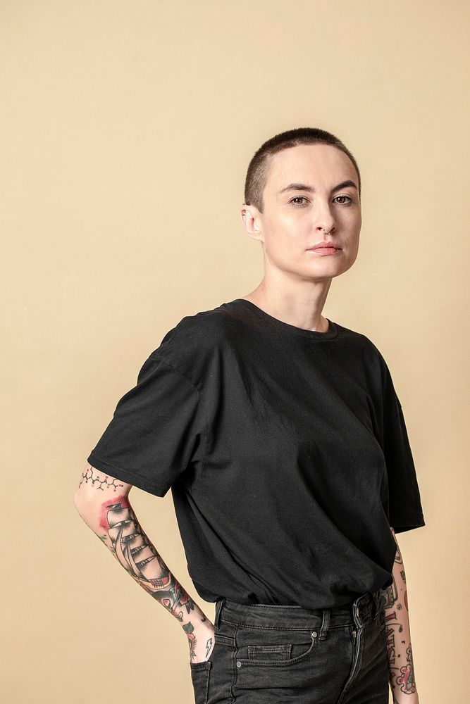 Model with tattoo in black T shirt and jeans