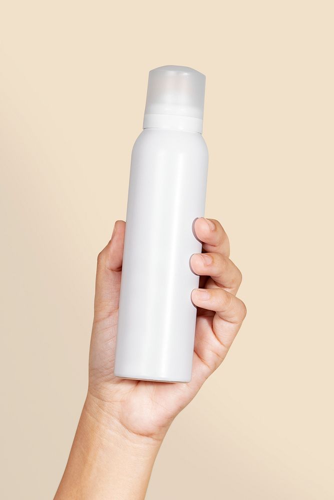 Black woman holding a white spray bottle