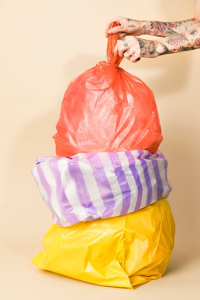 Colorful garbage bags on yellow background