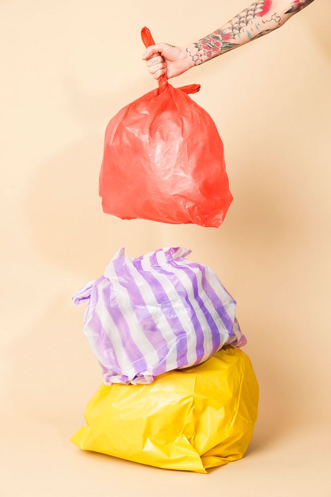 Colorful garbage bags isolated on yellow background