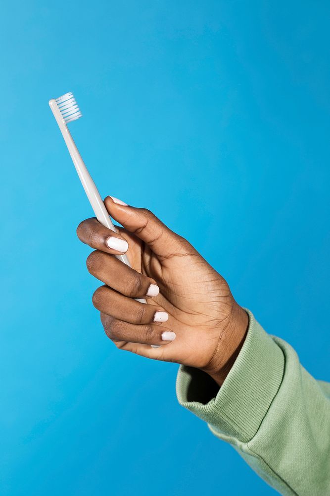Black woman holding a toothbrush 