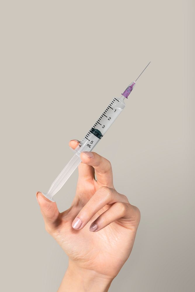 Hand holding a syringe mockup