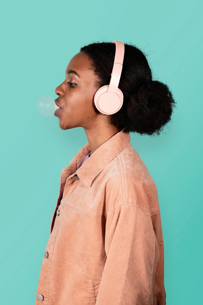 Black woman listening to the music and chewing bubble gum