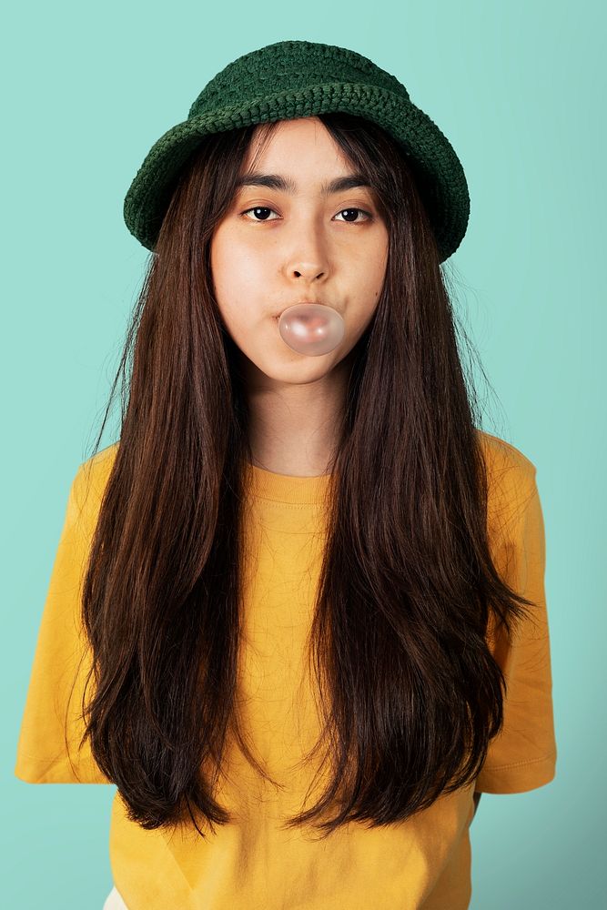 Cheerful girl blowing a bubble gummockup