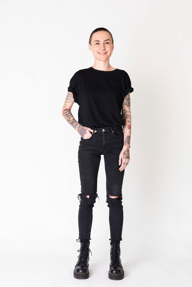 Skinhead model with tattoos in black T shirt and jeans