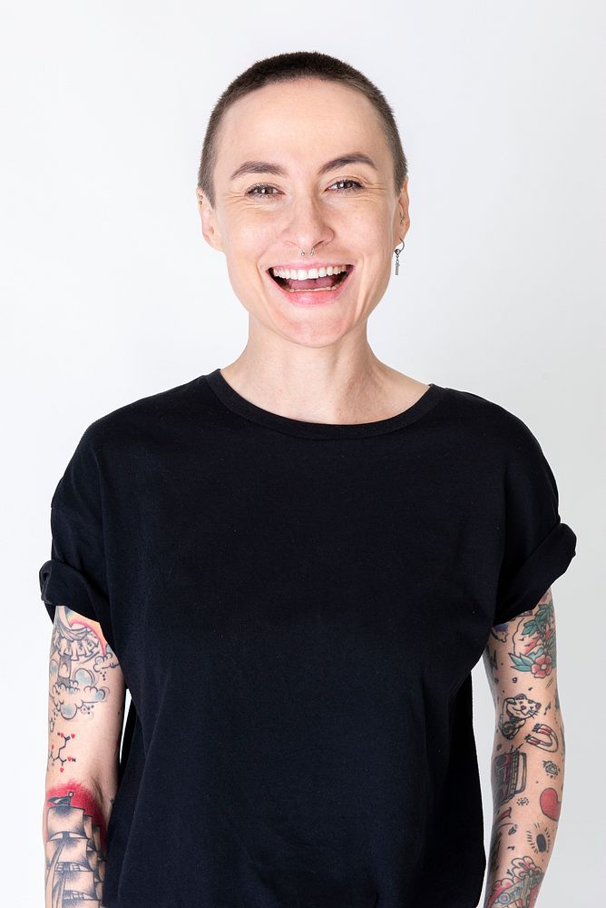Happy skinhead model with tattoos in black T shirt