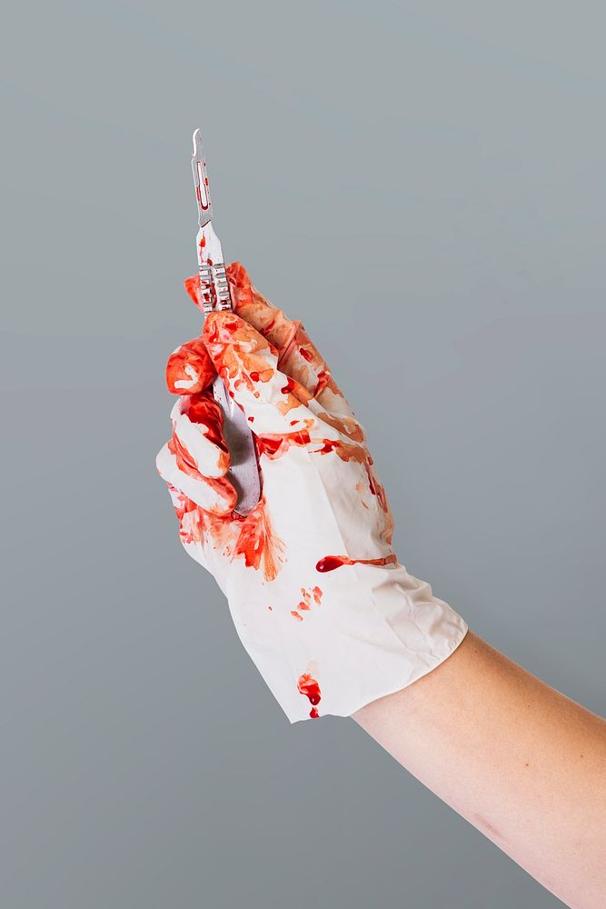 Doctor bloody hand in glove holding a scalpel