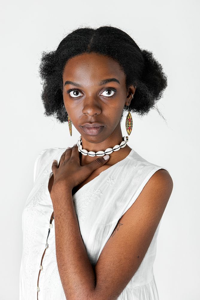 Confident black girl holding her necklace