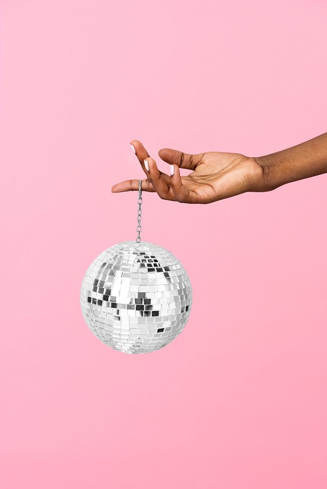Woman holding a shiny silver disco ball