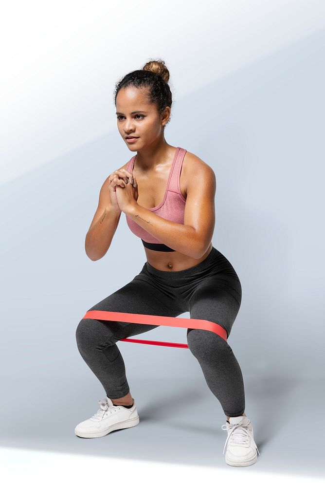 Active woman using a hip band in a squat position