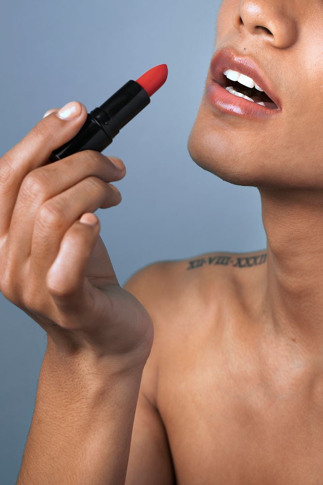 Closeup beautiful woman applying lipstick