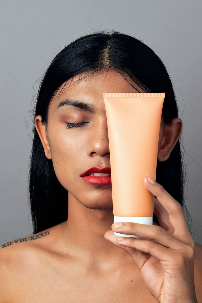 Woman holding a facial cream container
