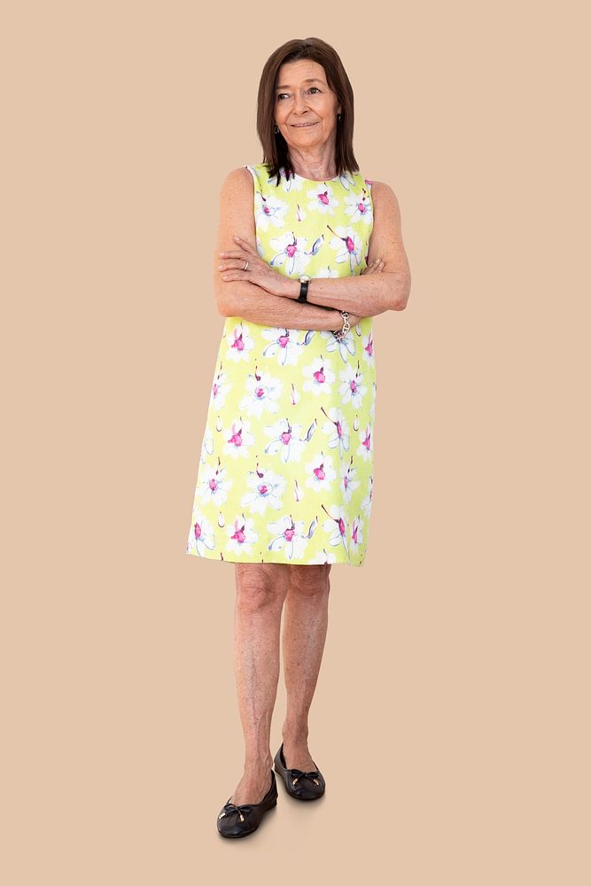 Happy senior woman in a floral dress against a wall mockup 