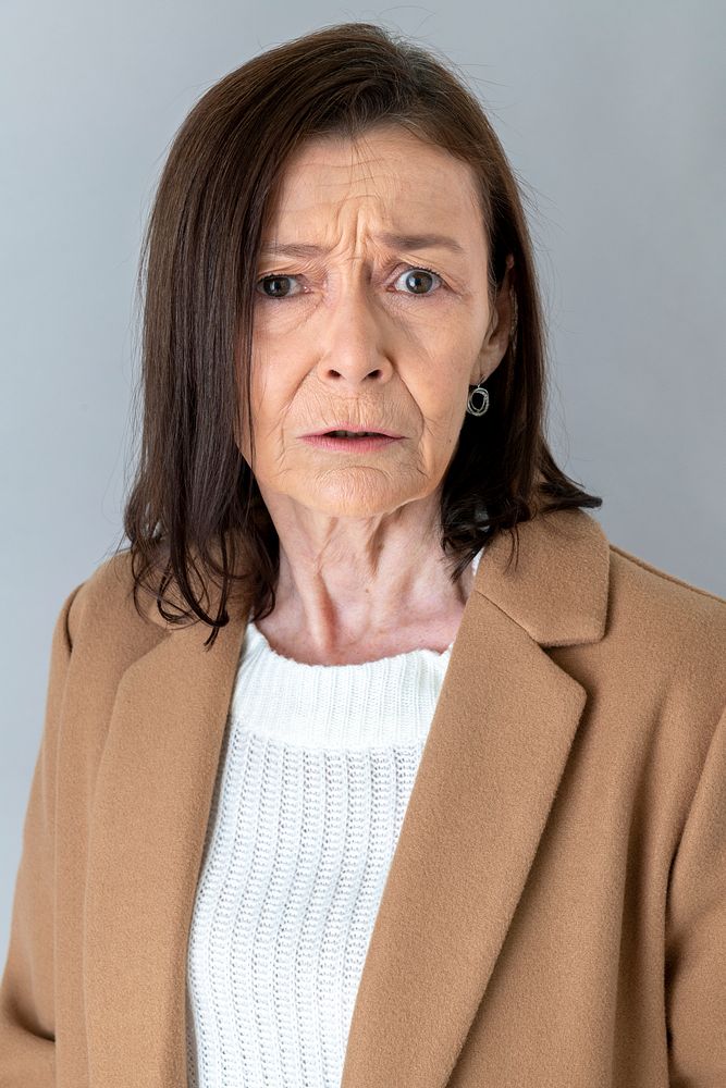 Annoyed senior woman in a blazer 
