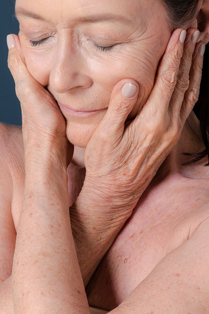 Close up of a senior woman touching her face