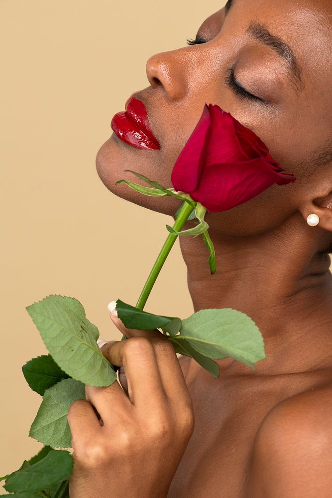 Portrait of a black woman with a red rose