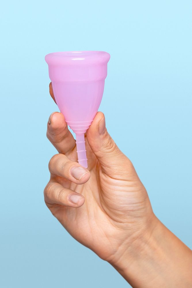 Hand holding pink menstrual cup mockup