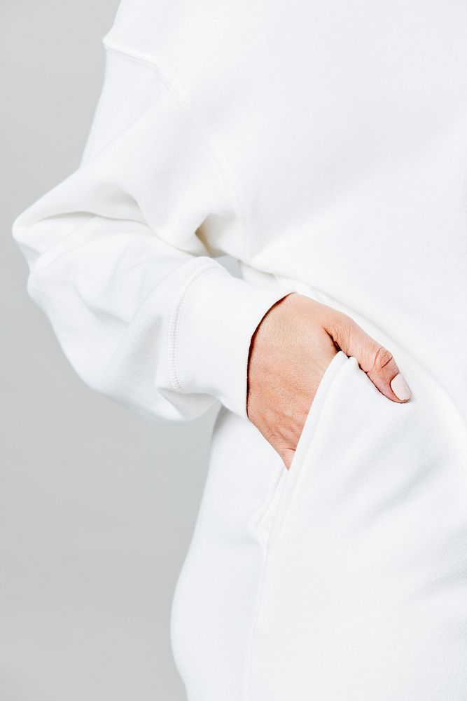Hand the in white sweater pocket