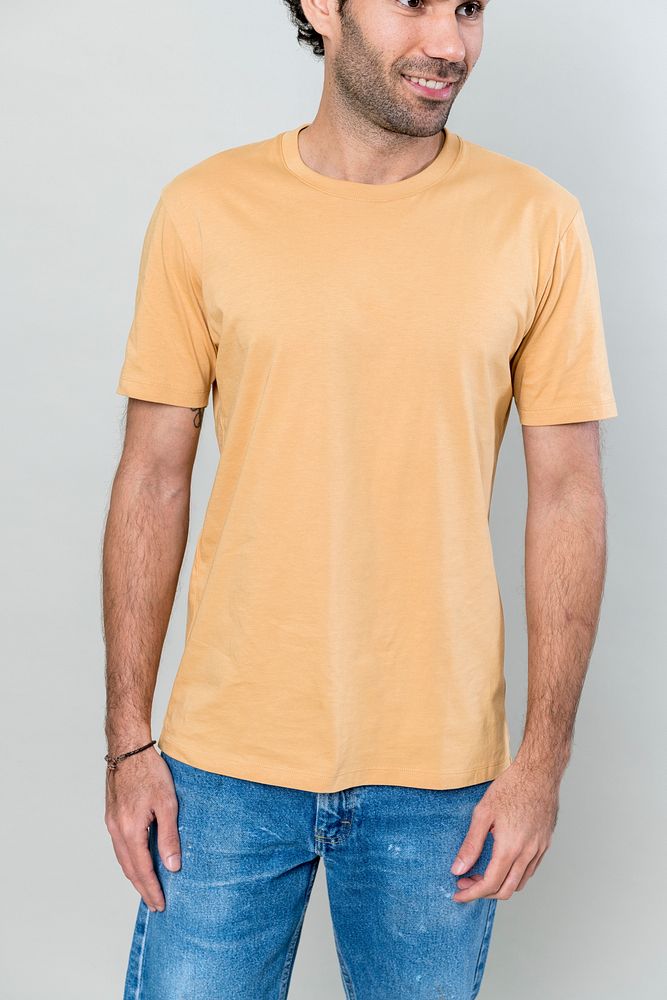Casual man wearing orange t-shirt and blue jeans